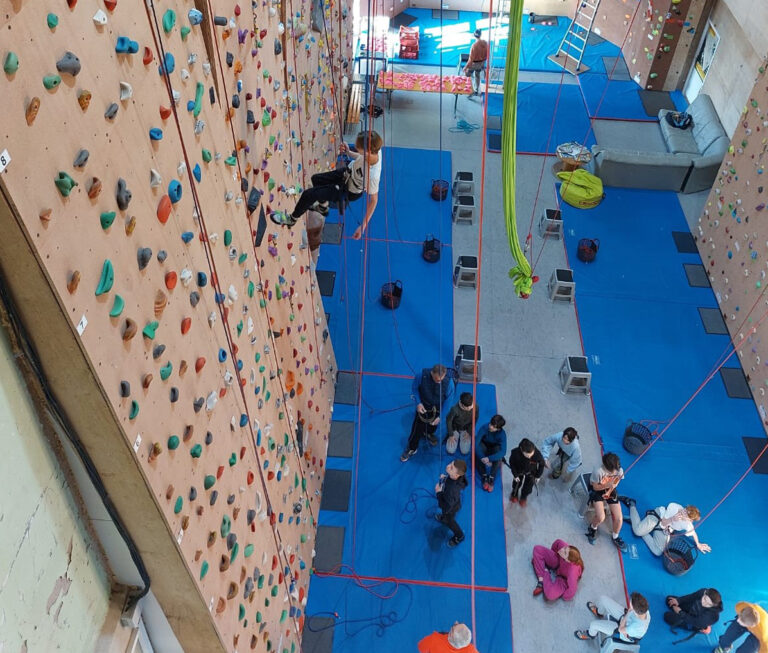 Vu d'en haut d'un mur d'escalade dans un gymnase avec les ados du Club Jeunes Vaison Ventoux.
